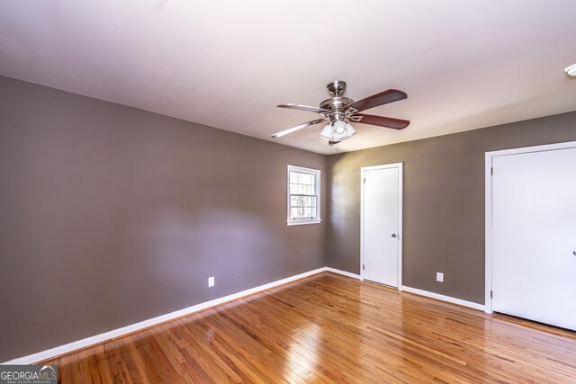 spare room featuring ceiling fan and hardwood / wood-style flooring