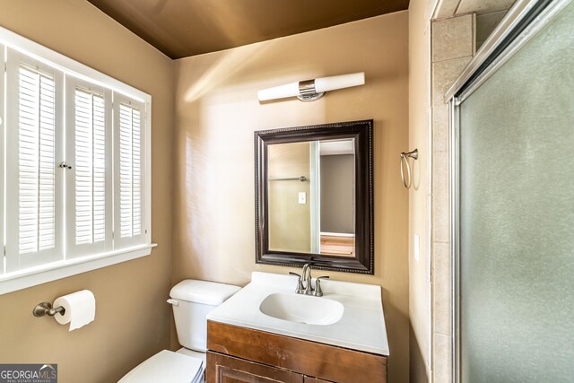 bathroom with vanity, toilet, and walk in shower