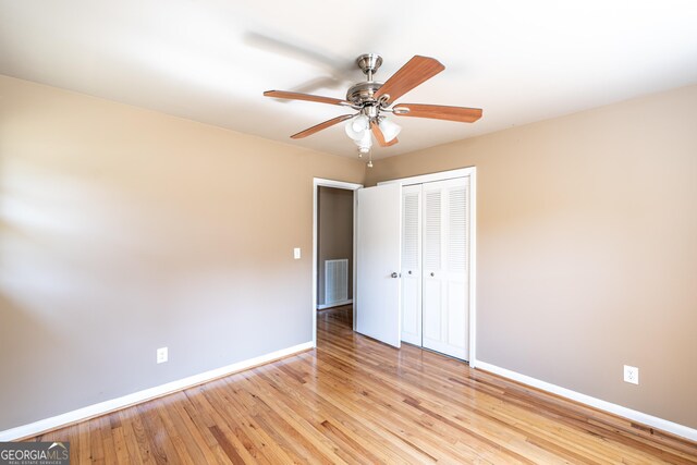 unfurnished bedroom featuring a closet, ceiling fan, and light hardwood / wood-style flooring