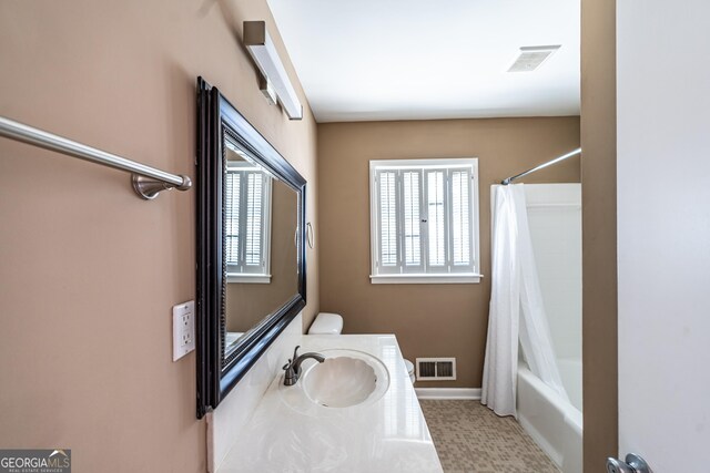 full bathroom featuring toilet, shower / tub combo, and vanity