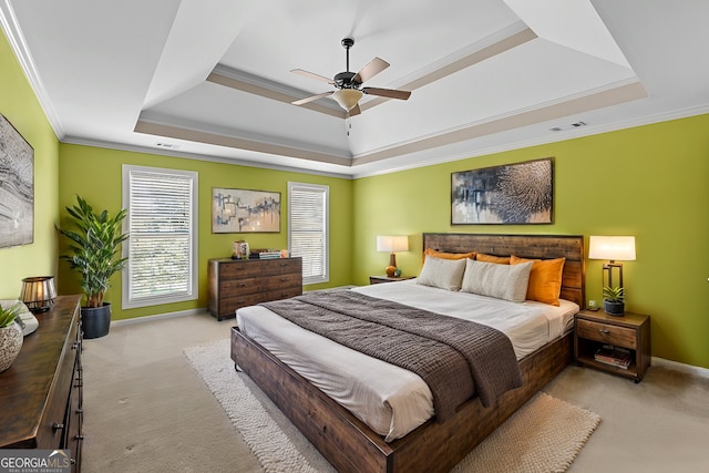 bedroom featuring a tray ceiling, ceiling fan, light carpet, and ornamental molding