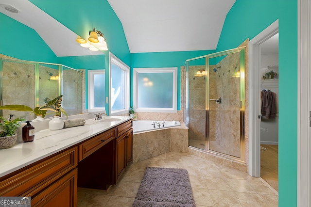 bathroom featuring independent shower and bath, vanity, tile patterned floors, and lofted ceiling