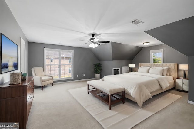 carpeted bedroom with ceiling fan and lofted ceiling