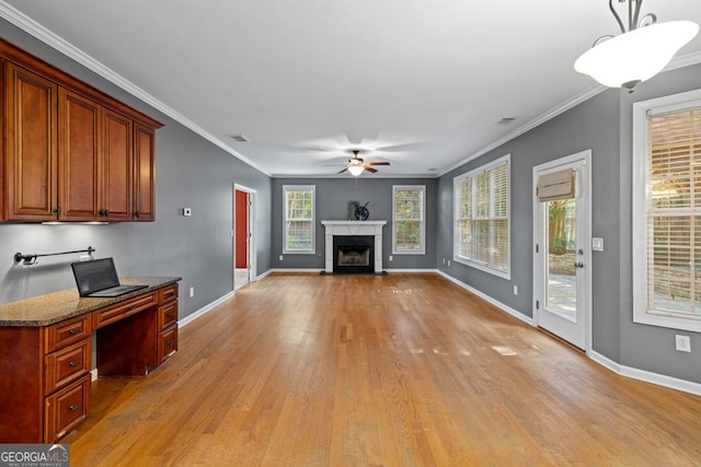 unfurnished living room featuring ceiling fan, light wood-type flooring, and ornamental molding