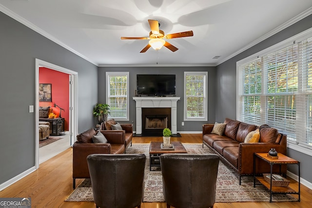 living room featuring light wood-type flooring, plenty of natural light, and ceiling fan