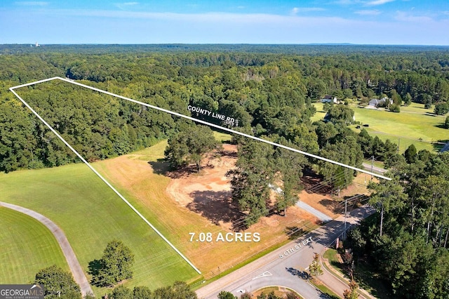 birds eye view of property with a rural view