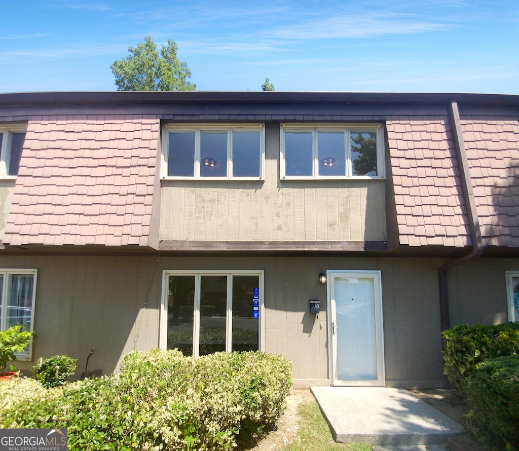 rear view of house with mansard roof