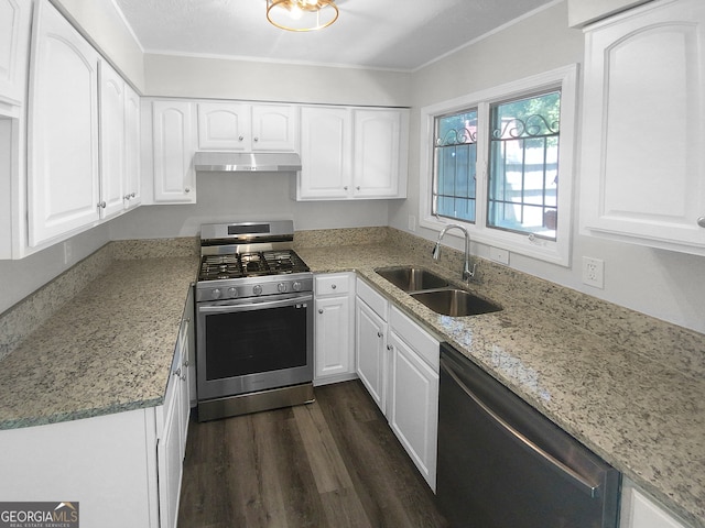 kitchen with light stone counters, stainless steel appliances, sink, dark wood-type flooring, and ornamental molding