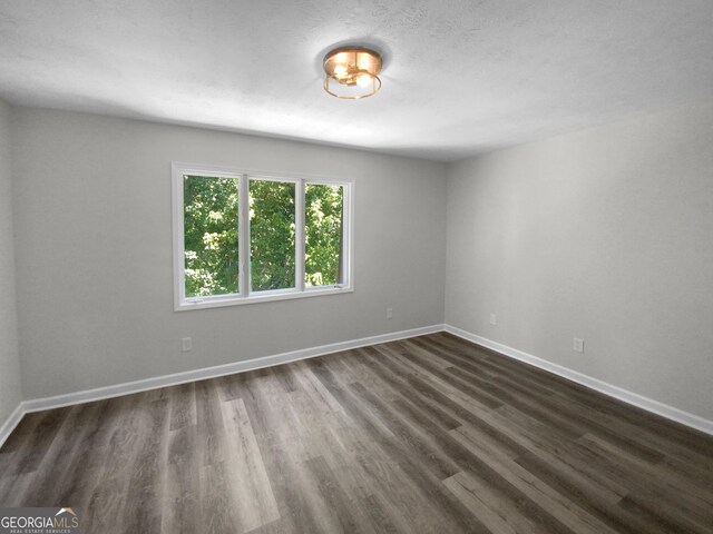 unfurnished room featuring dark hardwood / wood-style floors