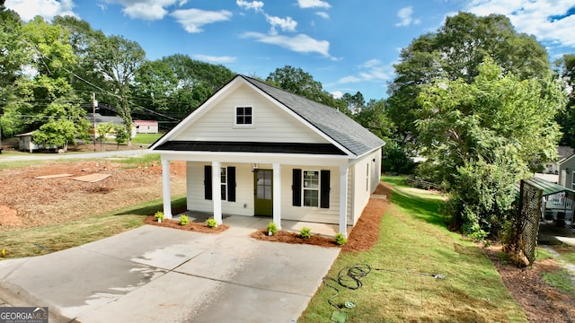 view of front of property with a front yard and a porch