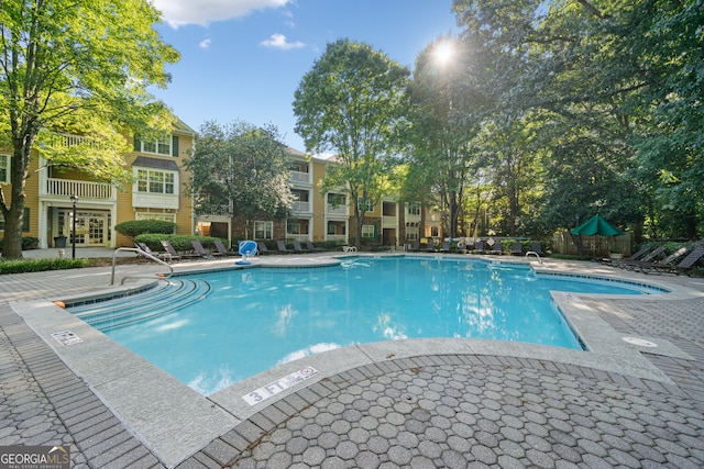 view of swimming pool with a patio