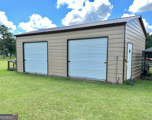 view of outbuilding with a garage and a yard