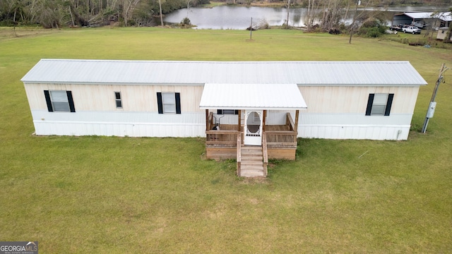 view of front of property with a front lawn and a water view