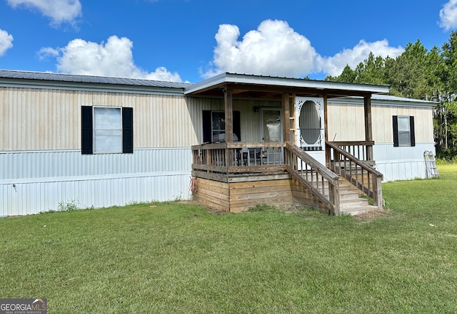 manufactured / mobile home with a porch and a front yard