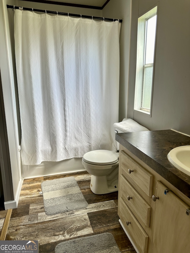 full bathroom featuring shower / bathtub combination with curtain, vanity, hardwood / wood-style floors, and plenty of natural light