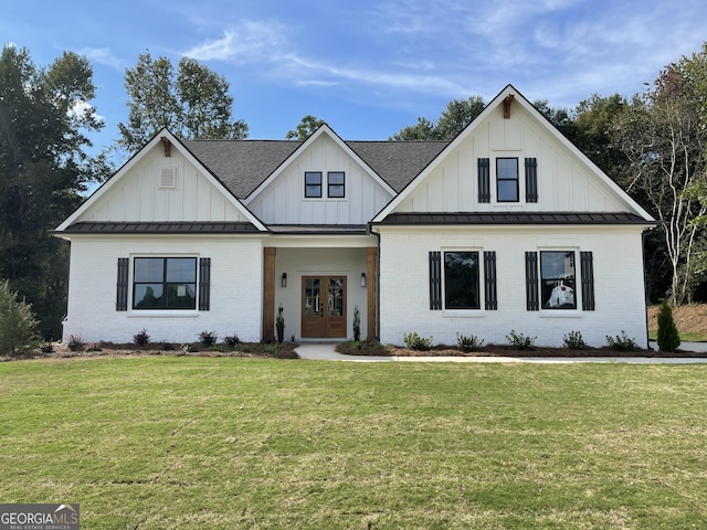 view of front of house with a front yard and french doors