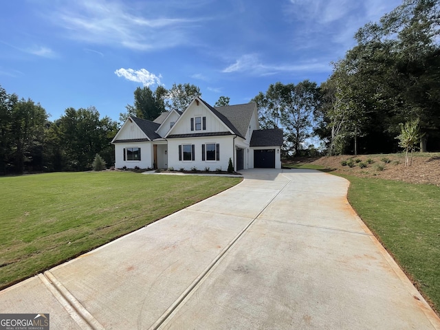 view of front of home featuring a front yard and a garage