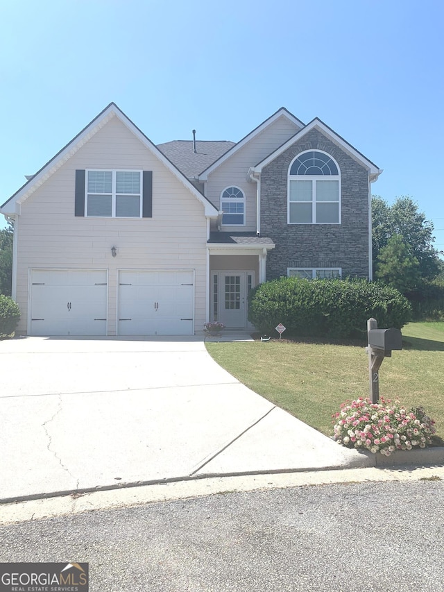 front facade with a garage and a front lawn