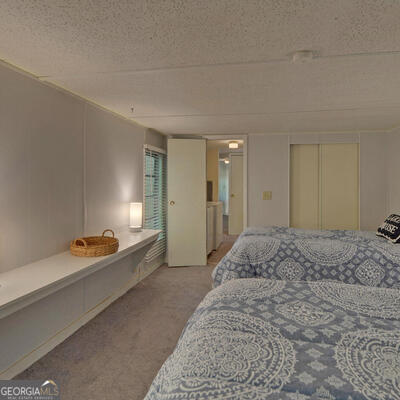 carpeted bedroom with a textured ceiling