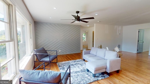 living room featuring hardwood / wood-style floors, ceiling fan, and a healthy amount of sunlight