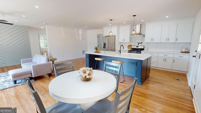 dining area featuring light hardwood / wood-style flooring and sink