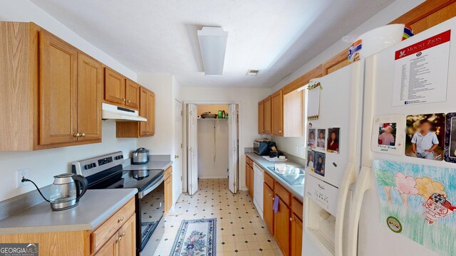 kitchen with white refrigerator with ice dispenser, stainless steel electric stove, and light tile patterned floors