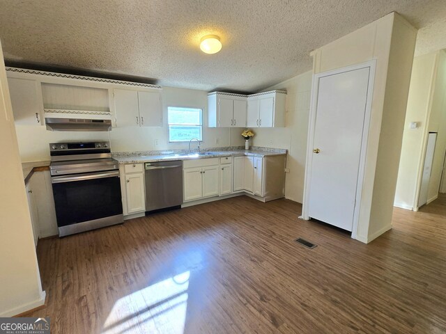 kitchen with white cabinetry, a textured ceiling, appliances with stainless steel finishes, and dark hardwood / wood-style flooring