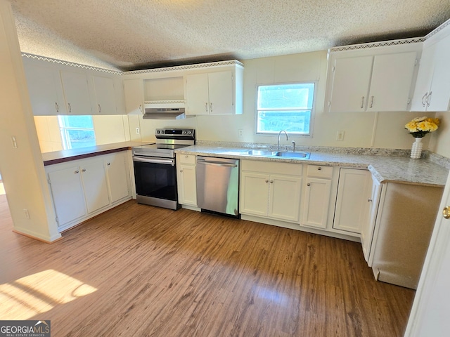 kitchen featuring appliances with stainless steel finishes, light hardwood / wood-style floors, sink, and white cabinets