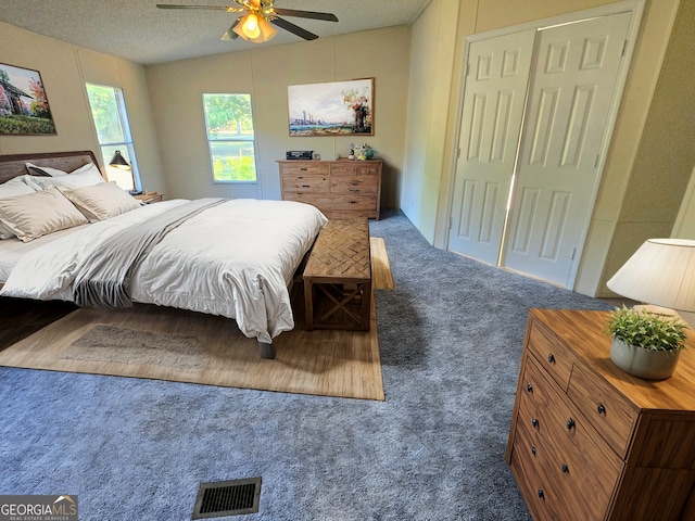 carpeted bedroom featuring vaulted ceiling, ceiling fan, and a textured ceiling