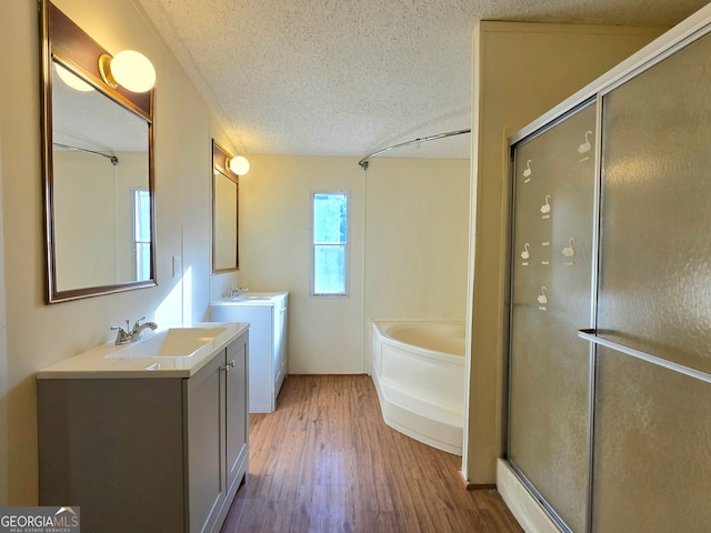 bathroom featuring independent shower and bath, a textured ceiling, vanity, and hardwood / wood-style flooring