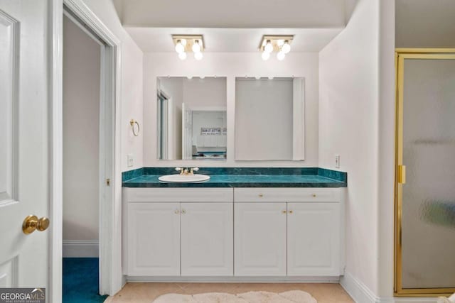 bathroom featuring vanity, tile patterned floors, and a shower with shower door