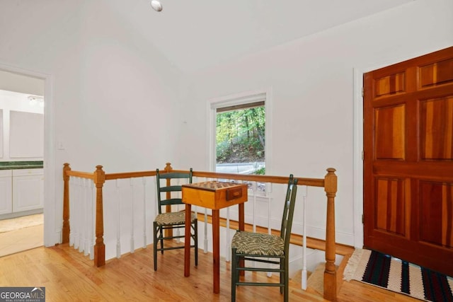 dining space with vaulted ceiling and light hardwood / wood-style flooring