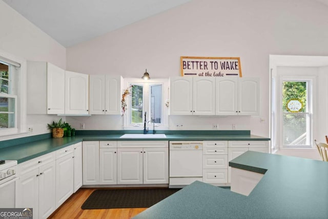 kitchen with sink, white cabinets, dishwasher, lofted ceiling, and light hardwood / wood-style flooring