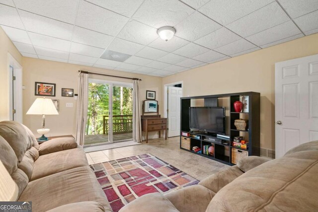 living room with a drop ceiling