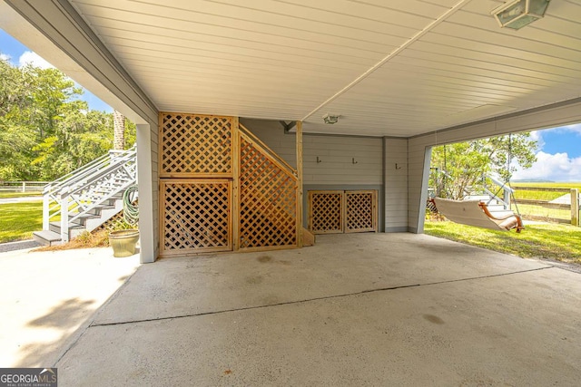 view of patio featuring a carport and stairway