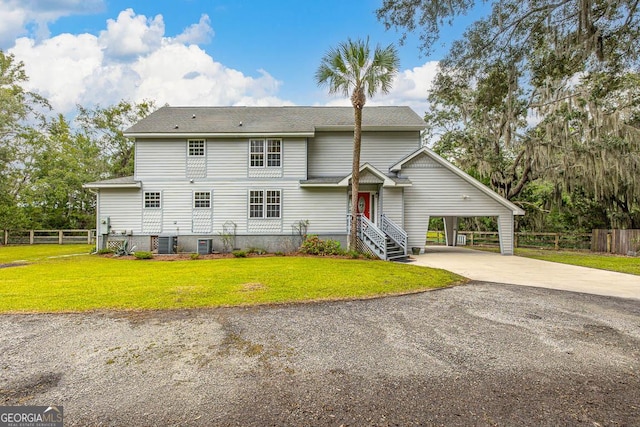 view of front of property with driveway, central AC unit, a front yard, and fence