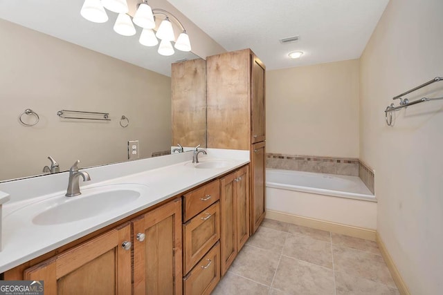 bathroom with tile patterned flooring, a garden tub, a sink, and double vanity