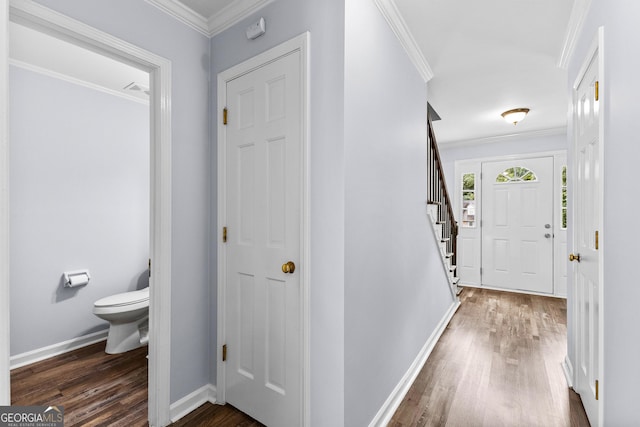 foyer entrance featuring baseboards, stairway, dark wood finished floors, and crown molding