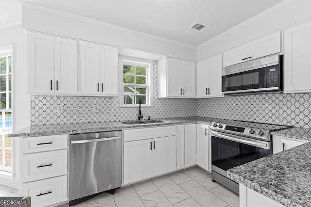 kitchen with marble finish floor, white cabinetry, stainless steel appliances, and a sink