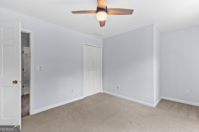 unfurnished bedroom featuring carpet floors, a closet, and baseboards