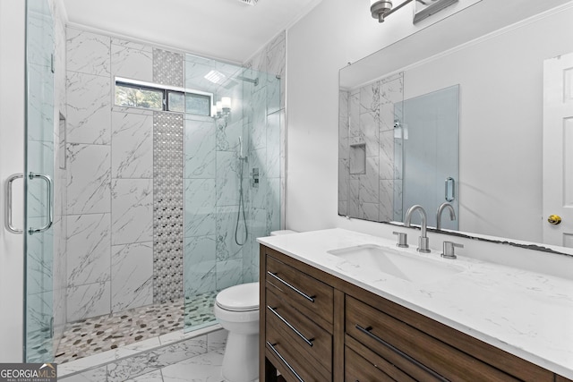 bathroom featuring toilet, marble finish floor, a marble finish shower, and vanity