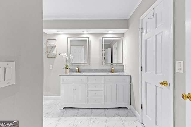 bathroom with ornamental molding, marble finish floor, a sink, and baseboards