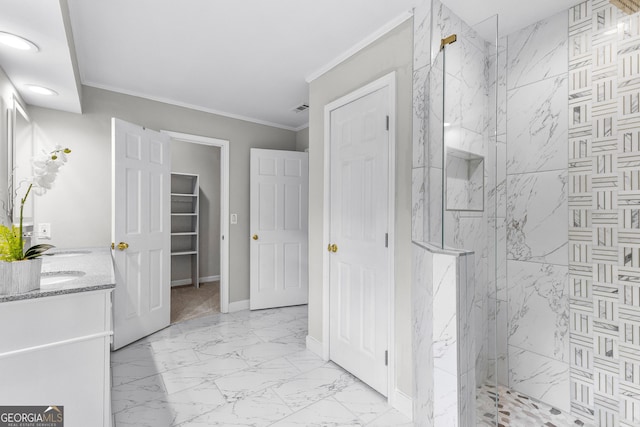 full bath featuring baseboards, marble finish floor, a marble finish shower, double vanity, and crown molding