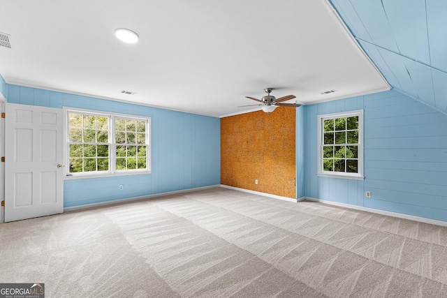 unfurnished living room featuring light carpet, baseboards, and visible vents