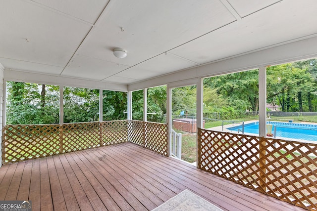 deck with fence and a fenced in pool