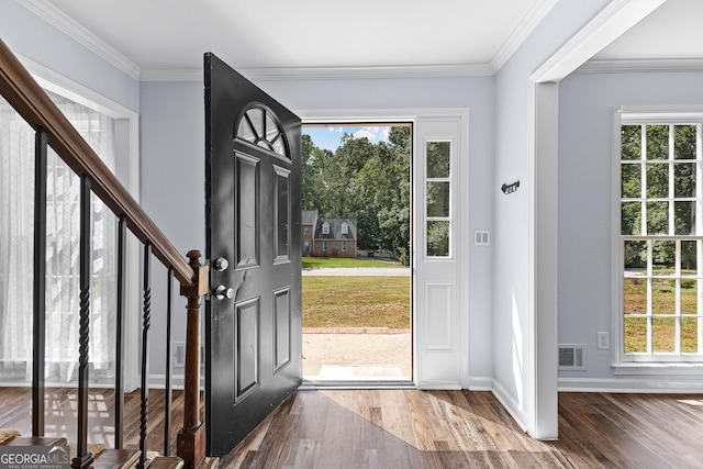 foyer featuring crown molding, visible vents, stairway, wood finished floors, and baseboards