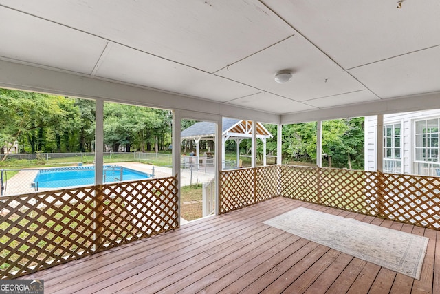 wooden deck with fence and a fenced in pool