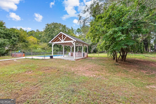 view of yard with a fenced in pool, a patio area, fence, and a gazebo