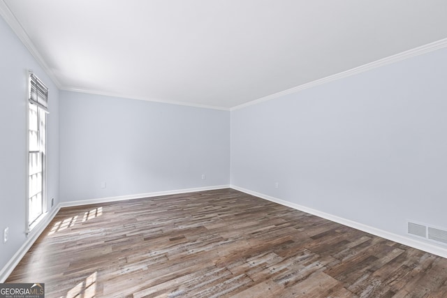 unfurnished room with ornamental molding, dark wood-type flooring, visible vents, and baseboards