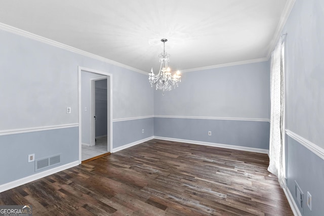 unfurnished room with dark wood-style floors, visible vents, ornamental molding, and baseboards